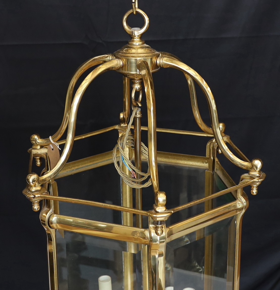 A large Georgian style hexagonal brass hall lantern with bevelled glass plates, height 79cm. width 48cm